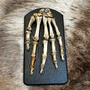 Human Left Hand on Wooden Plaque